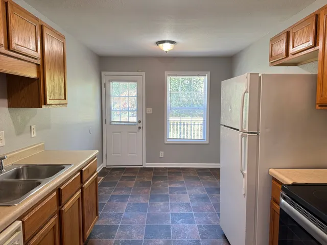 a kitchen with a refrigerator sink and stove
