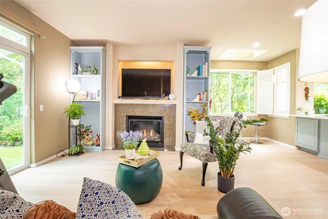 a living room with furniture a flat screen tv and a fireplace