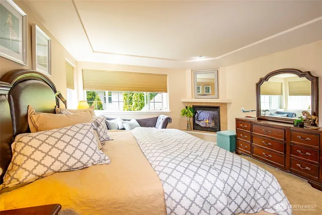 a bedroom with a bed and a fireplace with window