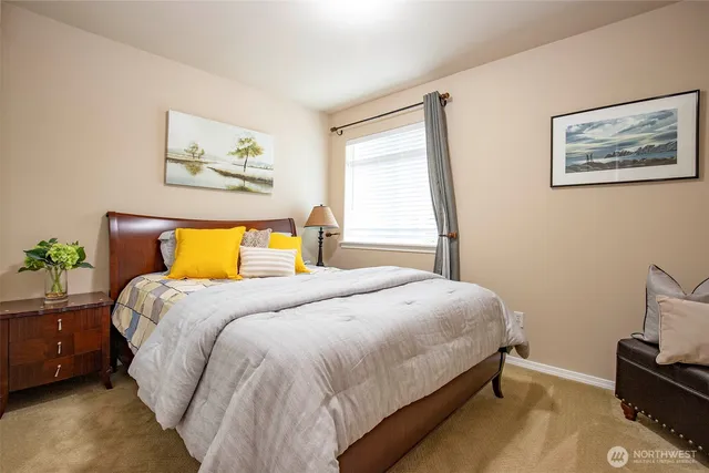 a bedroom with a bed and painting on the wall