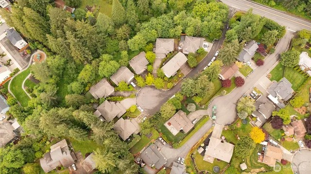 an aerial view of a house with a yard and garden