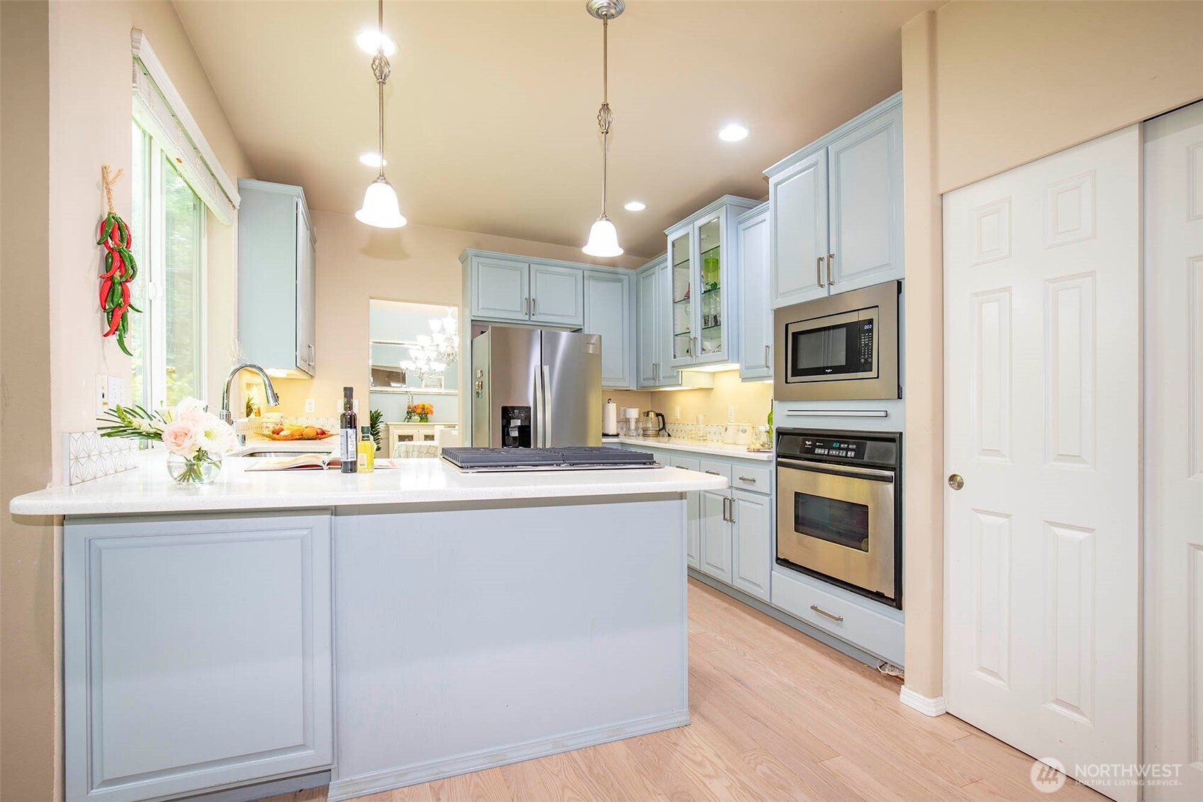 19 198th Place Southeast Bothell, WA 98012 - Photo 7 of 33 a kitchen with stainless steel appliances granite countertop a sink a stove a refrigerator and island with wooden floor
