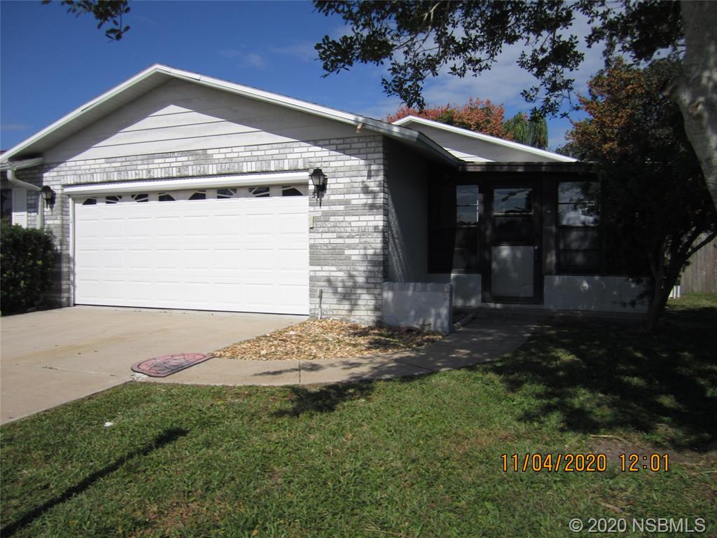 511 Cardinal Drive Edgewater, FL 32141 - Photo 1 of 13 a front view of a house with garden