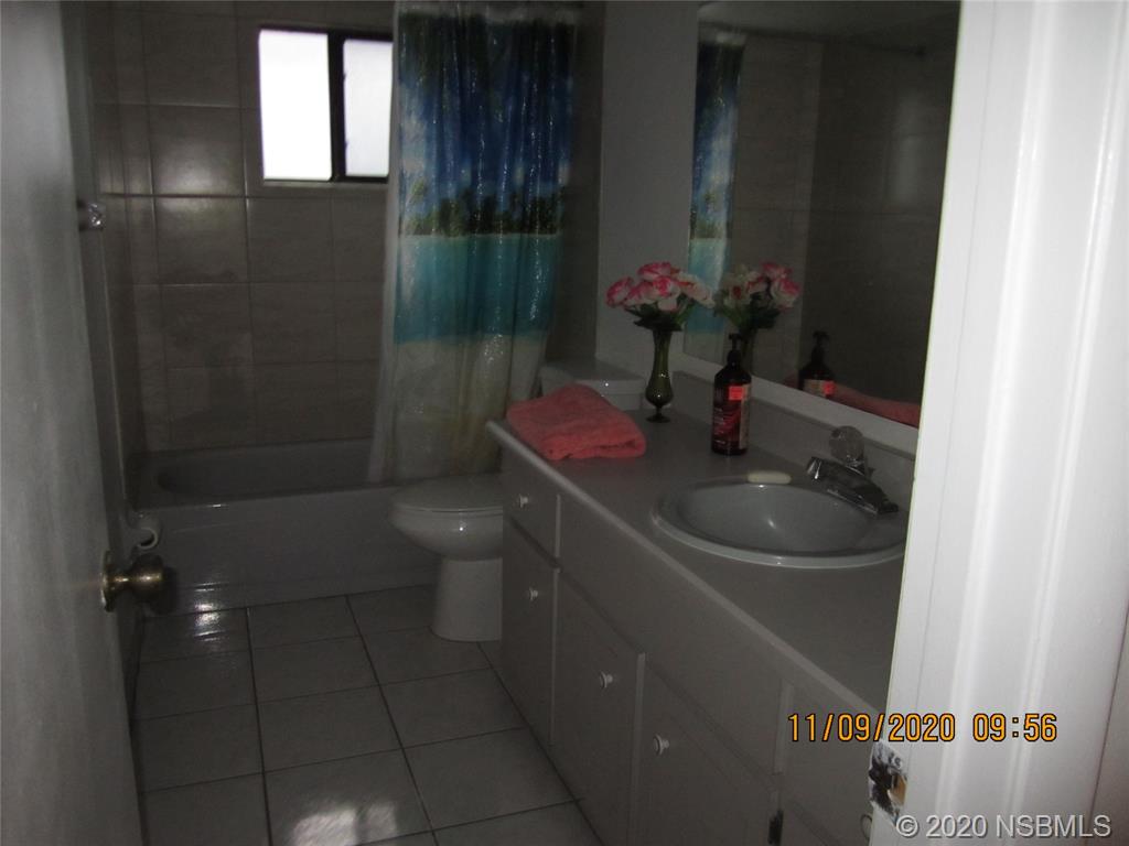 511 Cardinal Drive Edgewater, FL 32141 - Photo 11 of 13 a bathroom with a sink toilet and shower