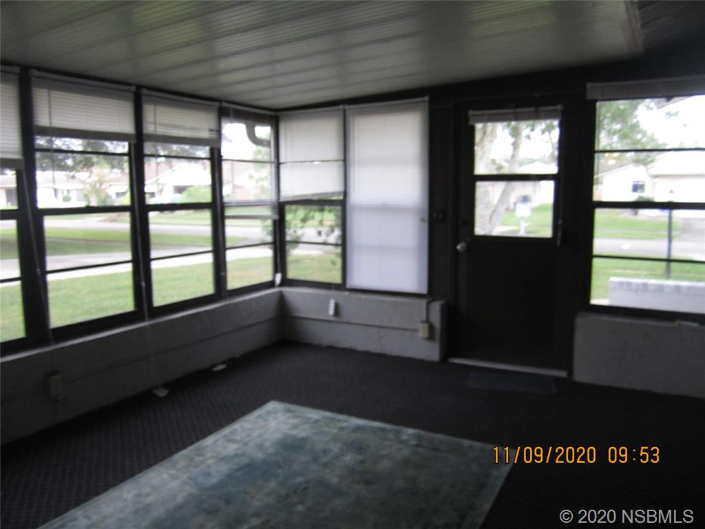 511 Cardinal Drive Edgewater, FL 32141 - Photo 3 of 13 wooden floor in an empty room with a window