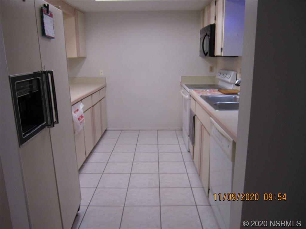 511 Cardinal Drive Edgewater, FL 32141 - Photo 4 of 13 a kitchen with a sink a stove top oven and cabinets