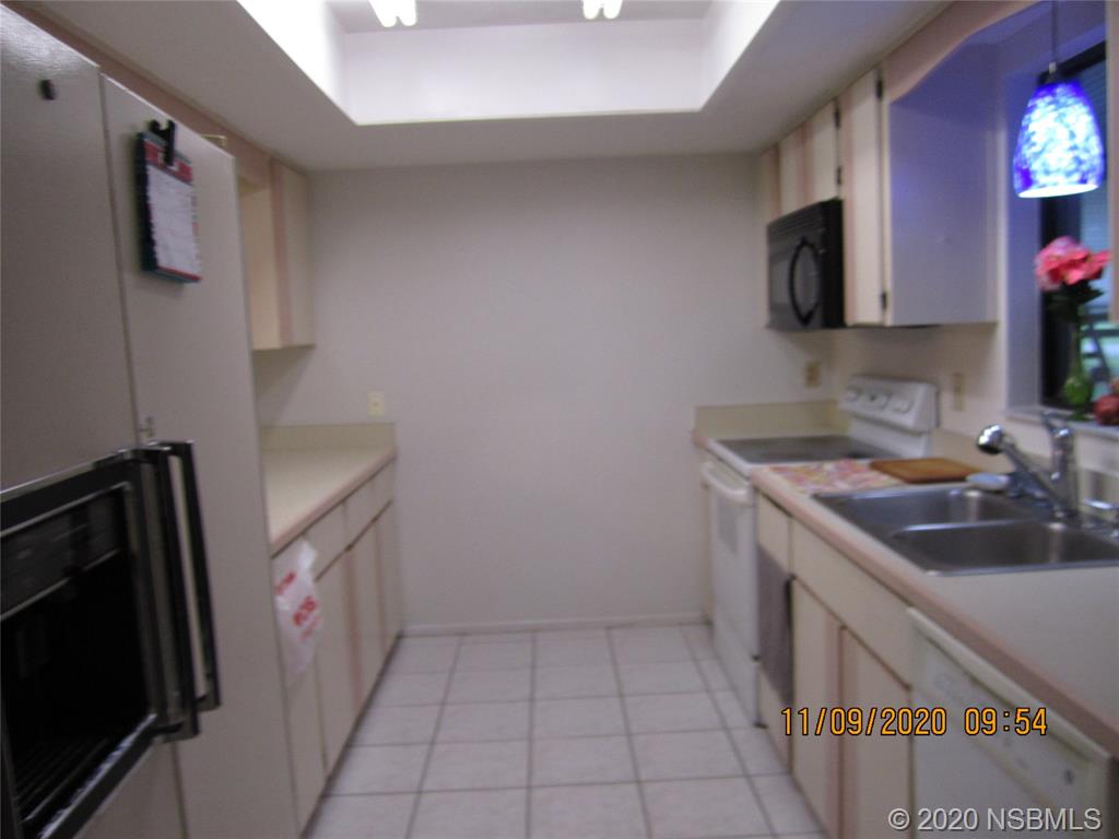 511 Cardinal Drive Edgewater, FL 32141 - Photo 5 of 13 a kitchen with sink cabinets and microwave