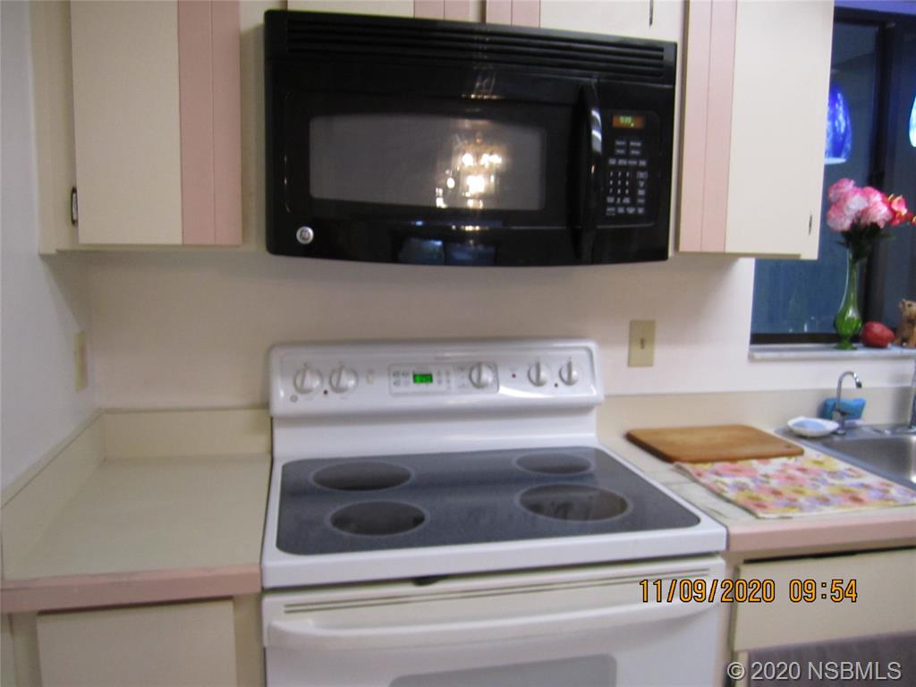 511 Cardinal Drive Edgewater, FL 32141 - Photo 6 of 13 a kitchen with a stove and a microwave