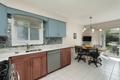 a view of a kitchen area with furniture window and wooden floor