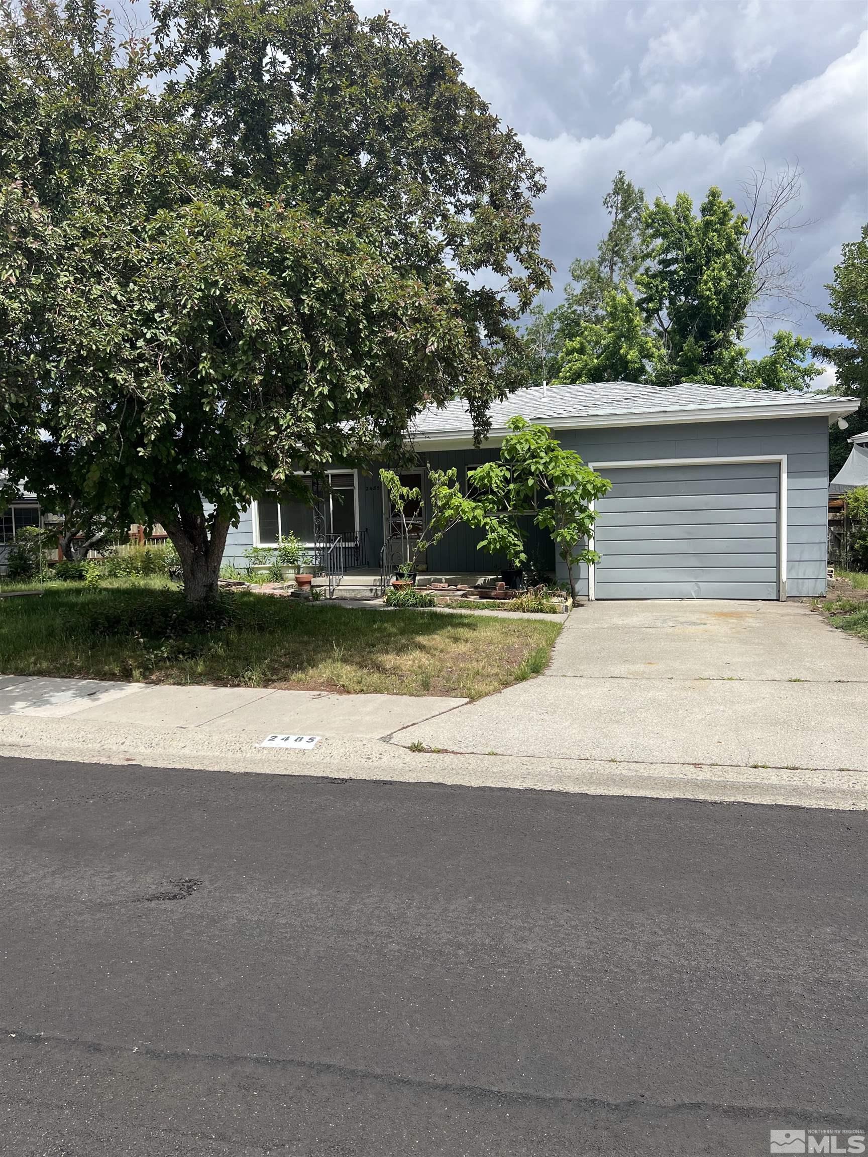 a view of a house with a yard and garage