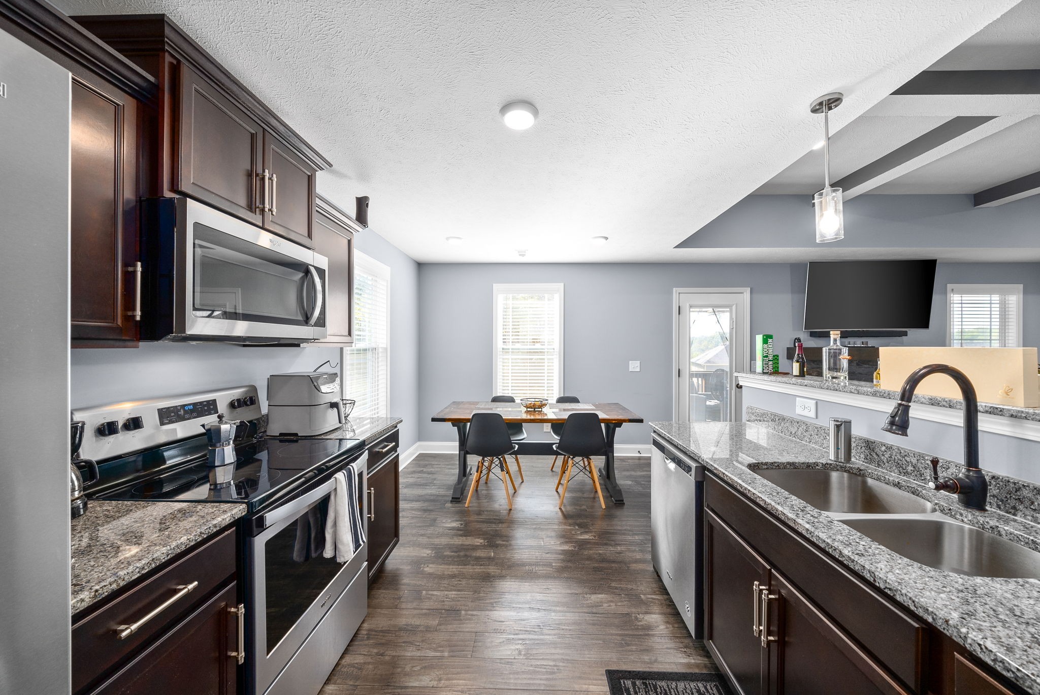 1807 Rains Road Clarksville, TN 37042 - Photo 15 of 39 a kitchen with granite countertop lots of counter top space a sink stainless steel appliances and cabinets