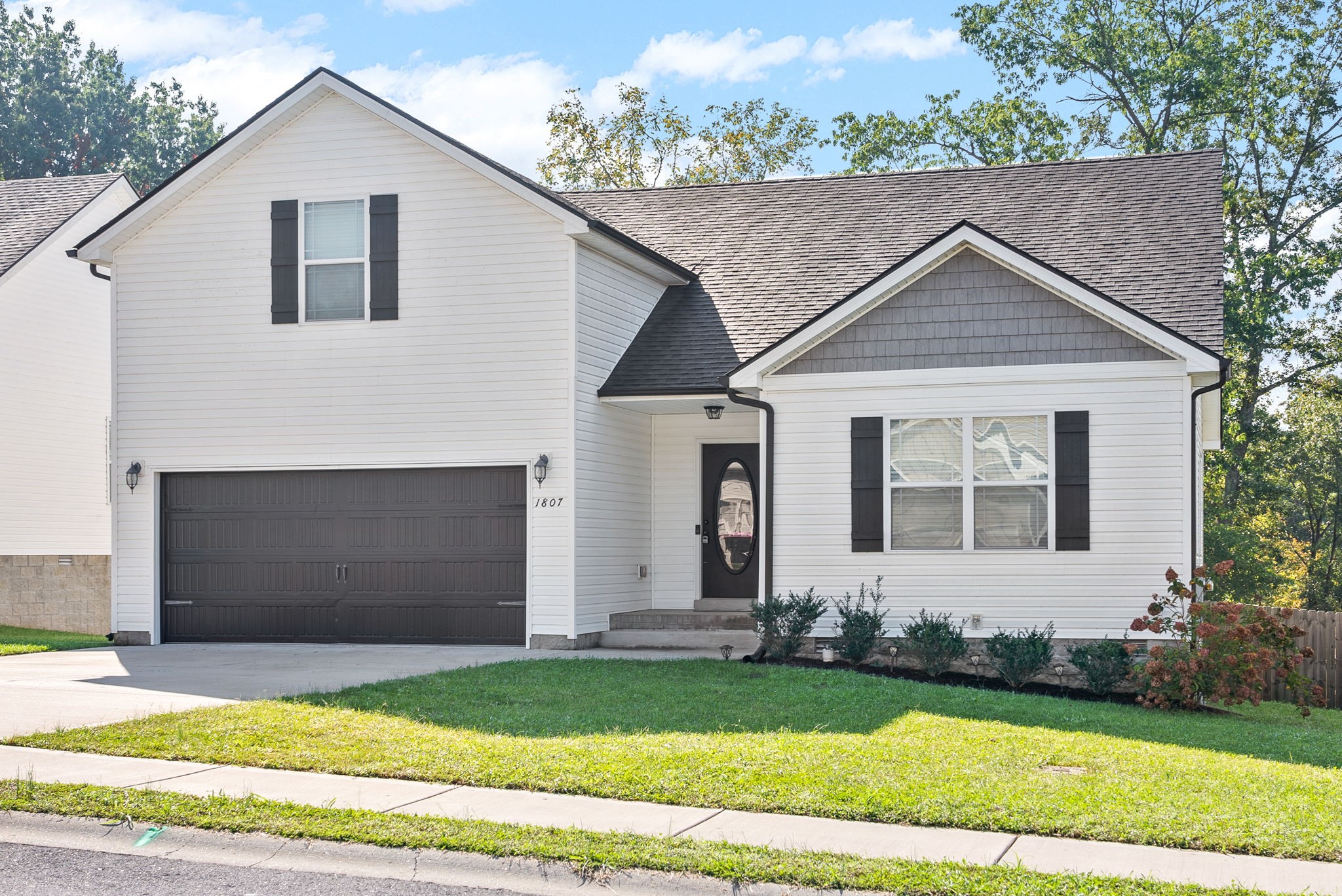 1807 Rains Road Clarksville, TN 37042 - Photo 2 of 39 a front view of a house with a garden and yard