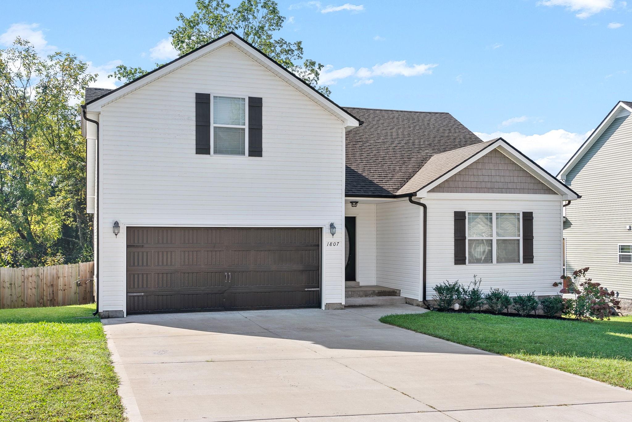 1807 Rains Road Clarksville, TN 37042 - Photo 3 of 39 a front view of a house with a yard and garage