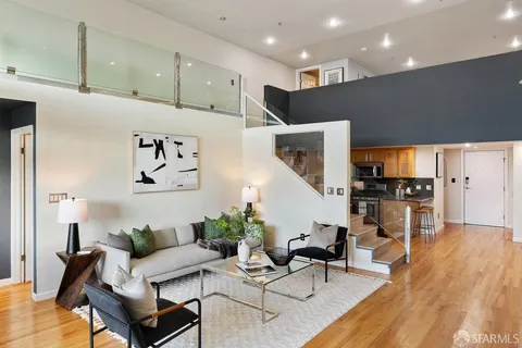 a living room with furniture and kitchen view