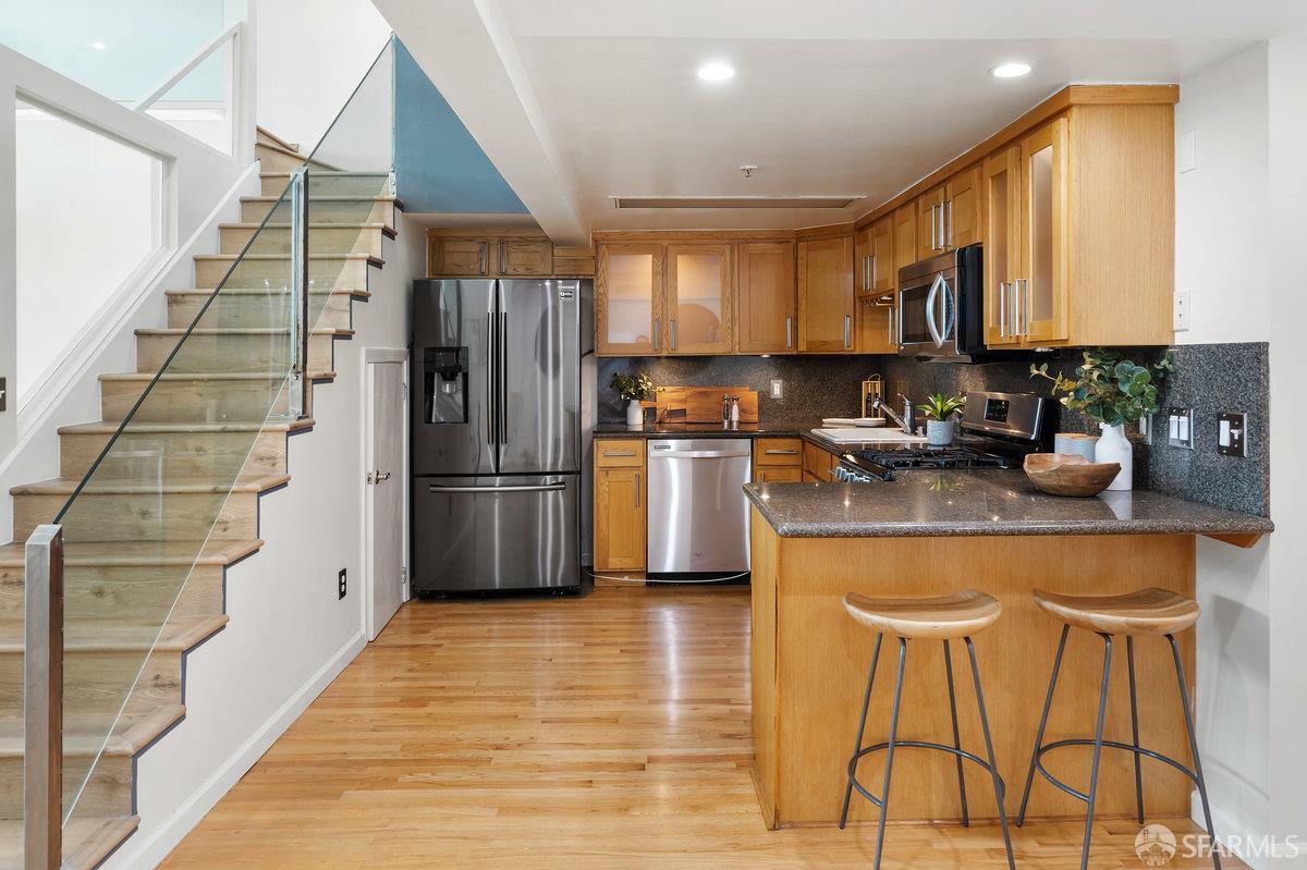 1578 Indiana Street, Unit 8 San Francisco, CA 94107 - Photo 11 of 36 a kitchen with granite countertop a refrigerator and a sink