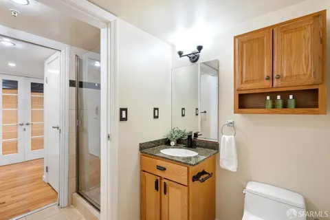 a bathroom with a sink a toilet and shower