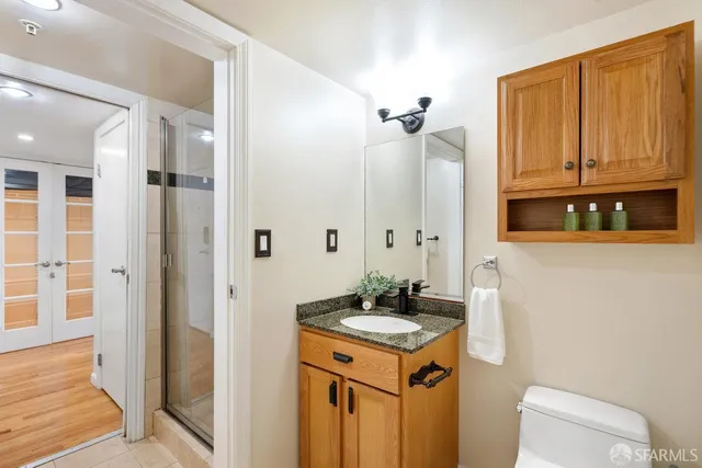 a bathroom with a sink a toilet and shower