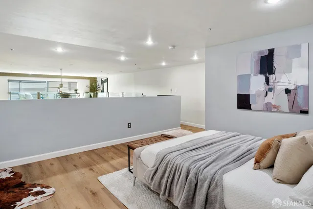 a bedroom with a bed and a large mirror