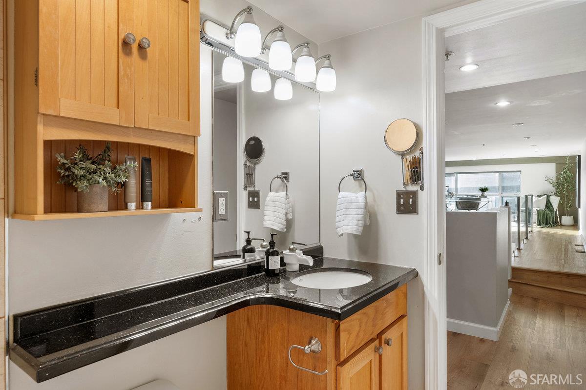 1578 Indiana Street, Unit 8 San Francisco, CA 94107 - Photo 24 of 36 a bathroom with a sink a mirror and vanity