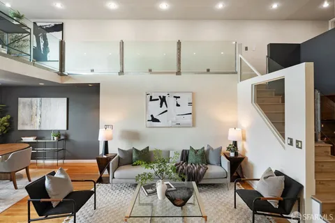 a living room with furniture and kitchen view