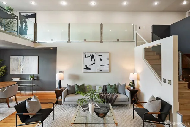 a living room with furniture and kitchen view