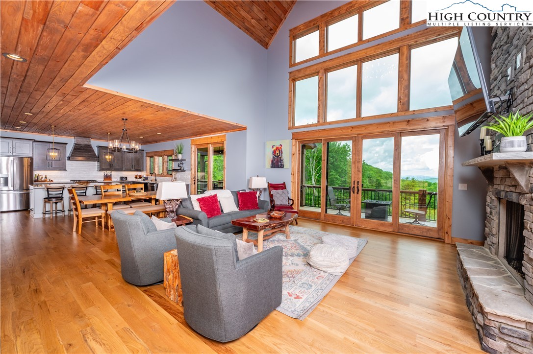 165 Eagle Pass Banner Elk, NC 28604 - Photo 15 of 41 a living room filled with furniture and a floor to ceiling window