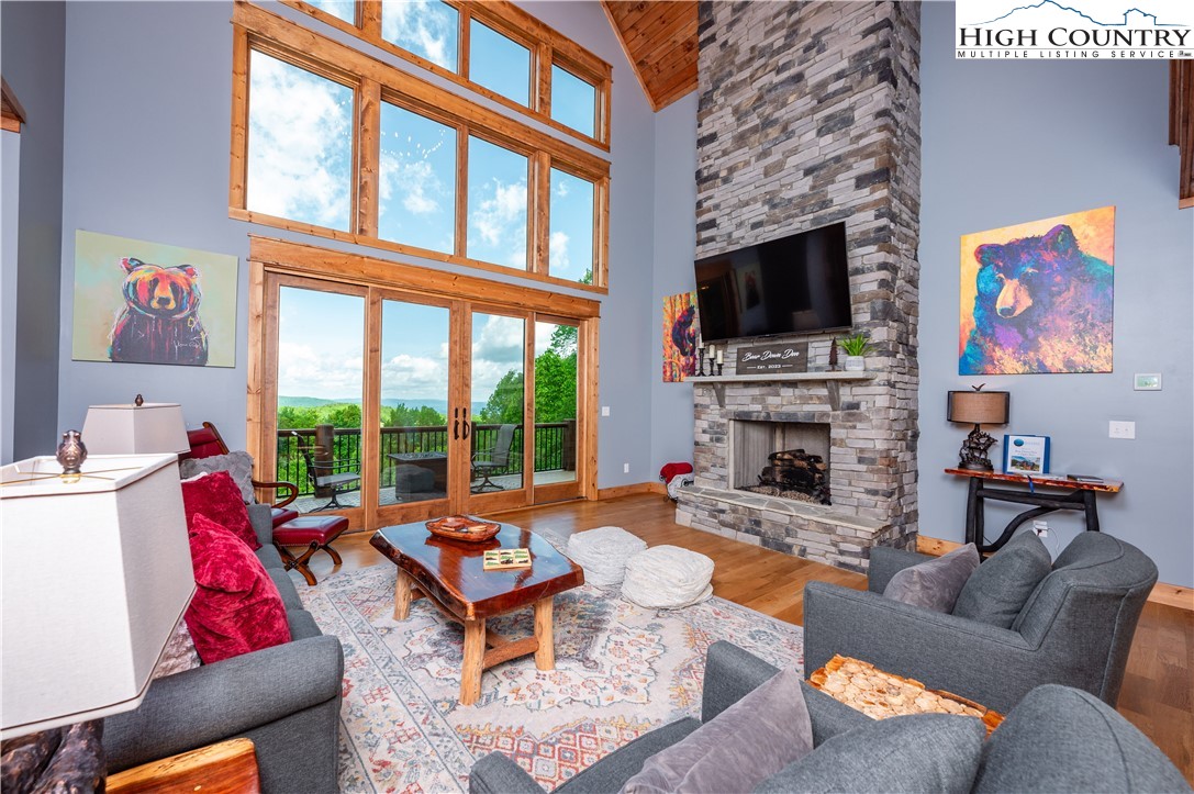 165 Eagle Pass Banner Elk, NC 28604 - Photo 17 of 41 a living room with furniture a flat screen tv and a fireplace