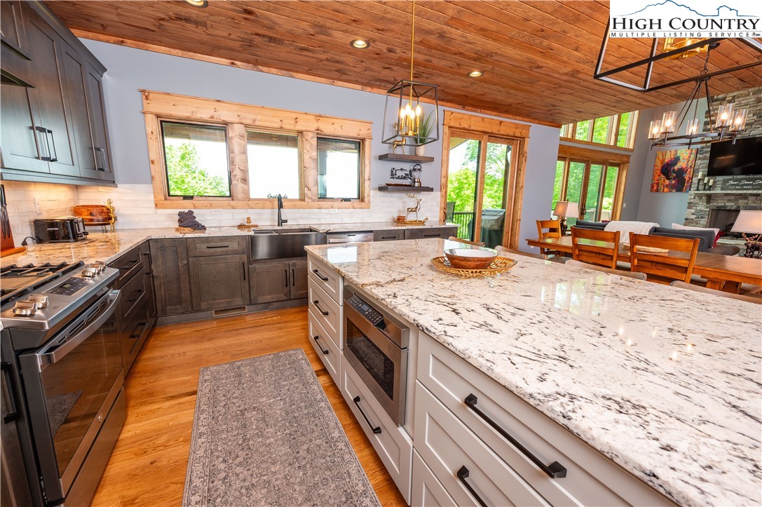165 Eagle Pass Banner Elk, NC 28604 - Photo 20 of 41 a kitchen with stainless steel appliances granite countertop sink stove and large window