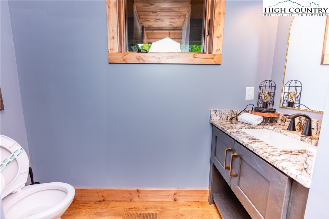 165 Eagle Pass Banner Elk, NC 28604 - Photo 23 of 41 a bathroom with a granite countertop sink and a toilet