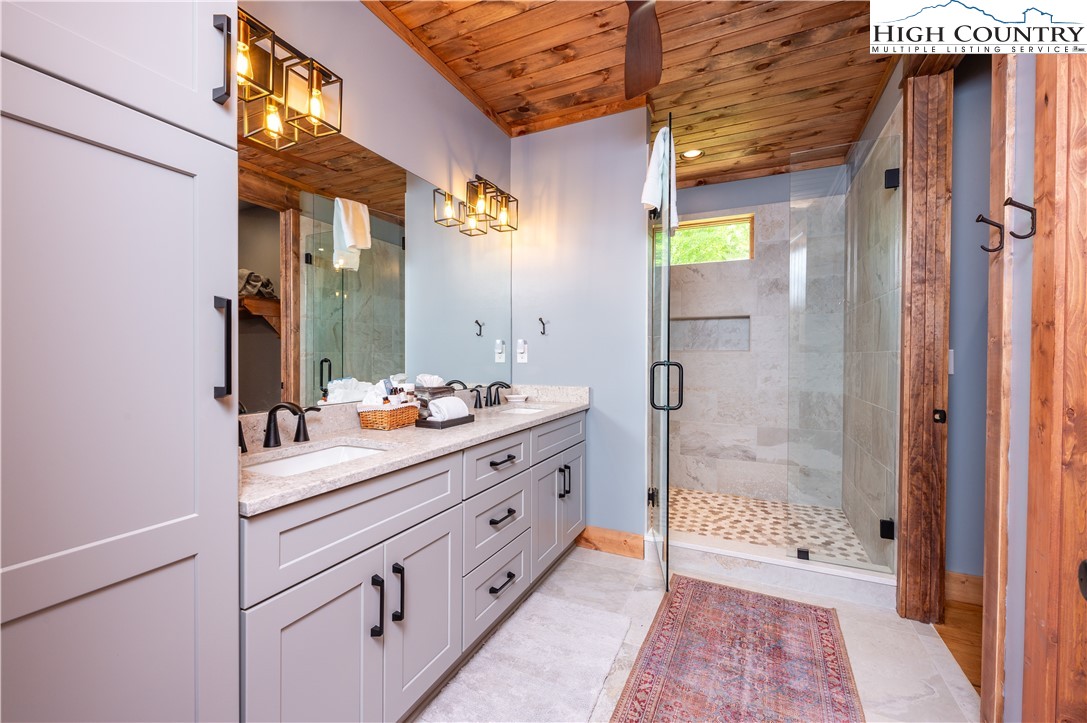 165 Eagle Pass Banner Elk, NC 28604 - Photo 25 of 41 a bathroom with a sink a mirror and a shower