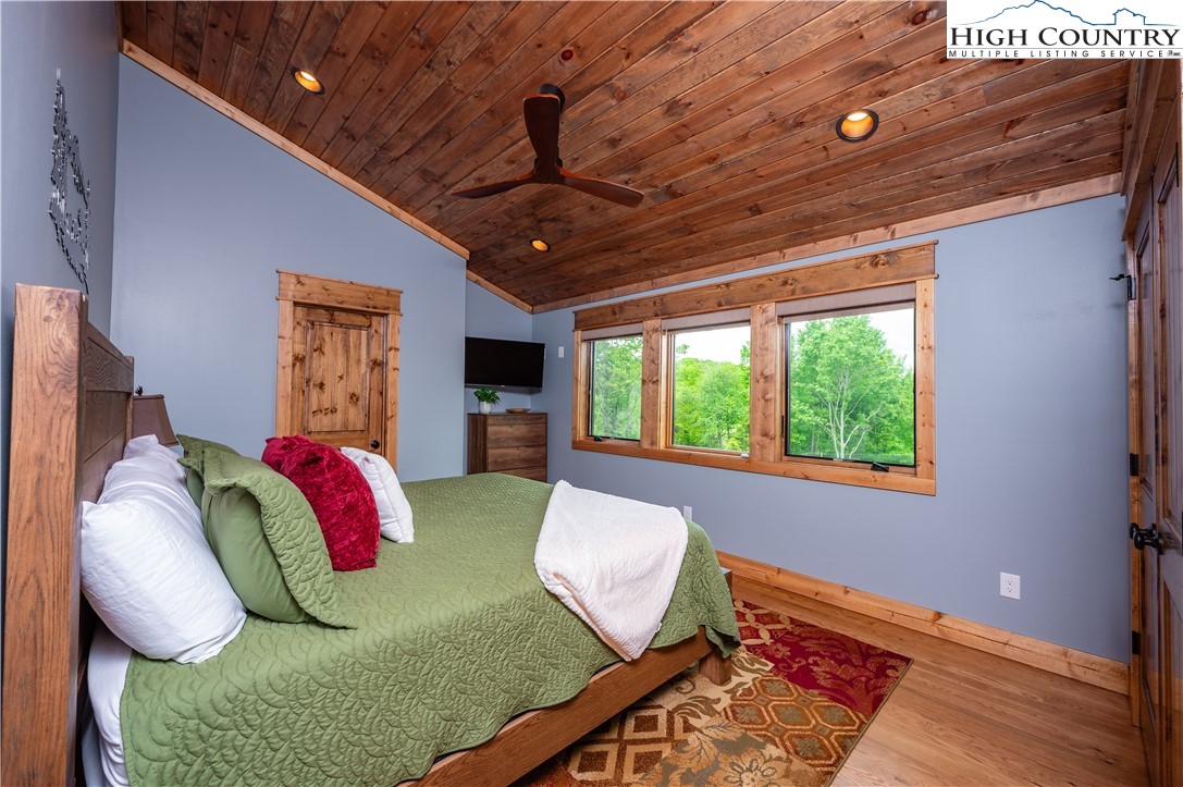 165 Eagle Pass Banner Elk, NC 28604 - Photo 35 of 41 a bed room with a bed mirror and a window