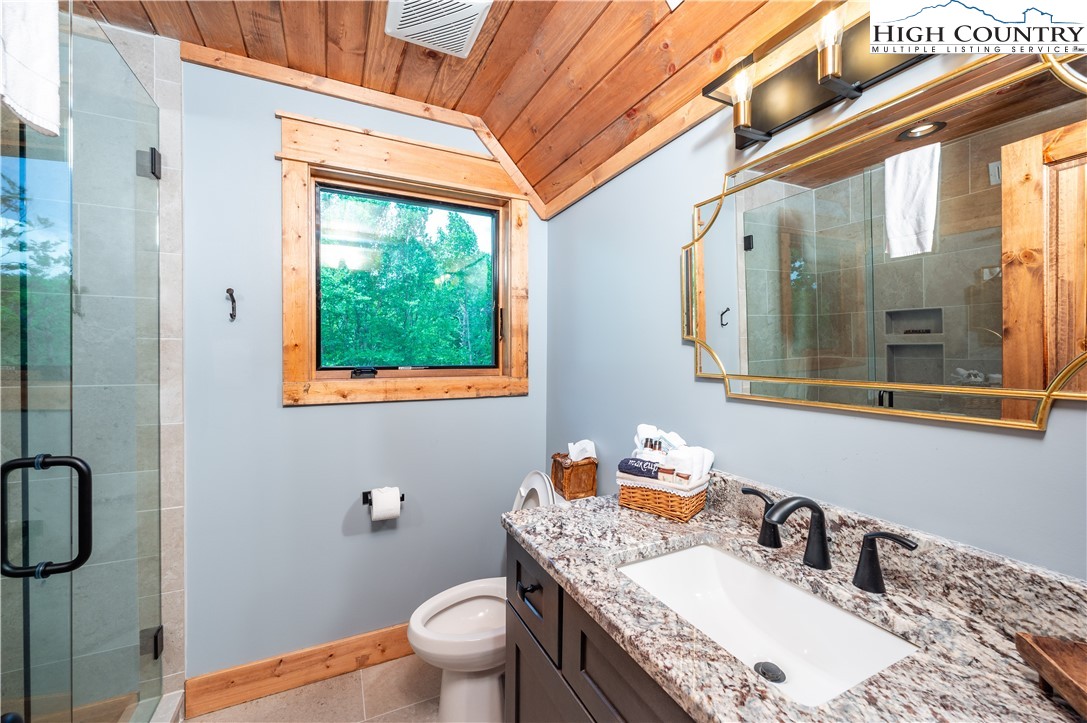 165 Eagle Pass Banner Elk, NC 28604 - Photo 37 of 41 a bathroom with a granite countertop sink a toilet and shower