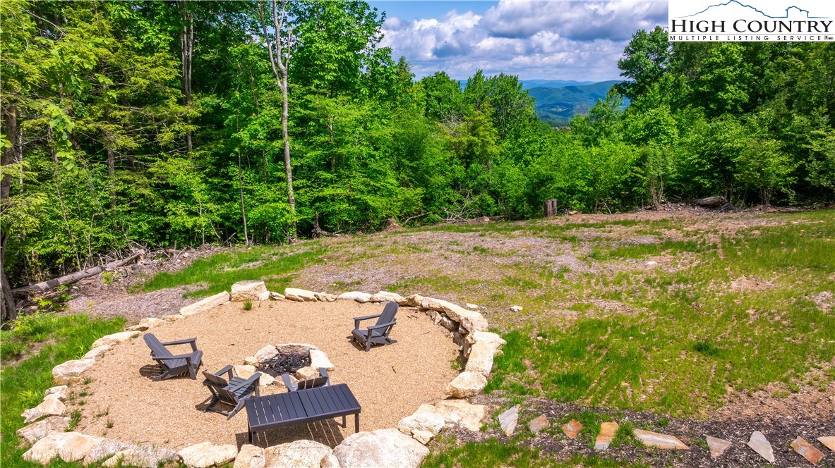165 Eagle Pass Banner Elk, NC 28604 - Photo 10 of 41 a view of a fire pit with a yard