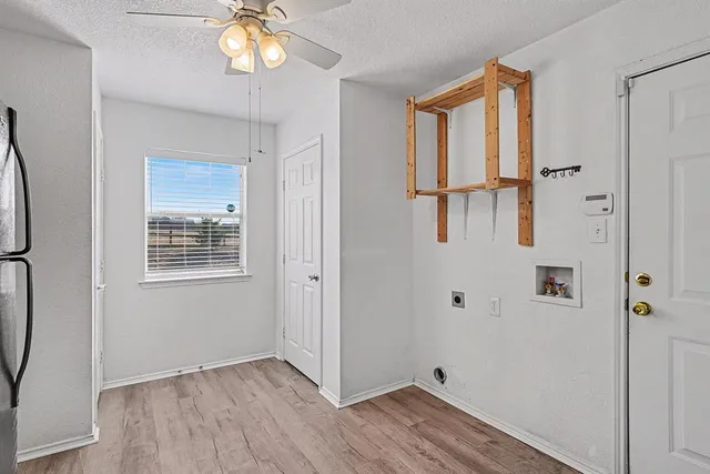 a view of an entryway with wooden floor