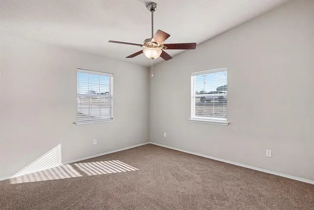 a view of a room with a ceiling fan and a window