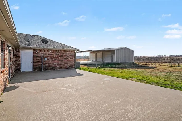 a view of a house with a swimming pool and a yard