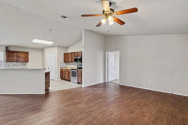 a view of a kitchen with a microwave and a ceiling fan
