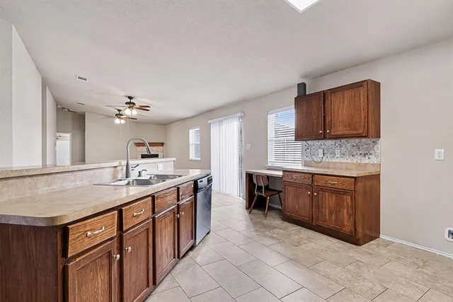 a kitchen with a sink stove and cabinets