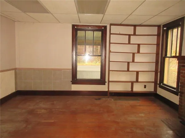 an empty room with windows and closet