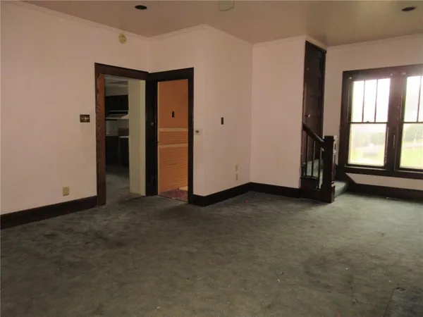 an empty room with windows and closet