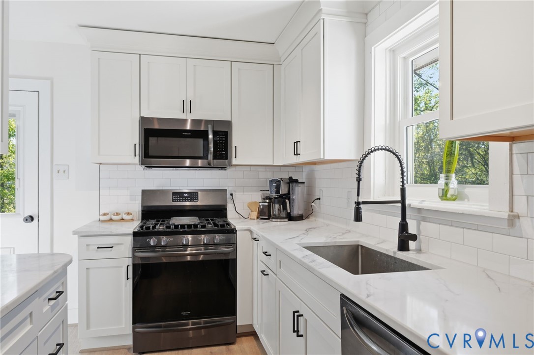 1100 Hollins Road Henrico, VA 23229 - Photo 11 of 38 a kitchen with granite countertop a sink a stove and microwave