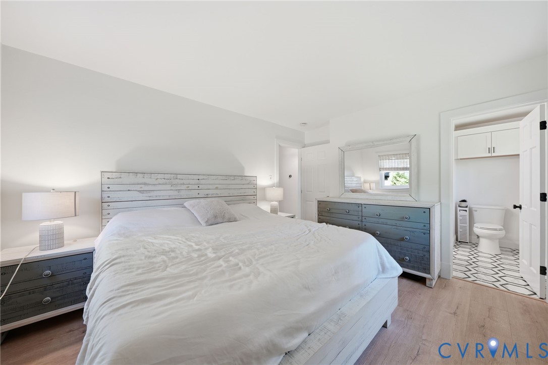 1100 Hollins Road Henrico, VA 23229 - Photo 18 of 38 a bedroom with a bed and a lamp