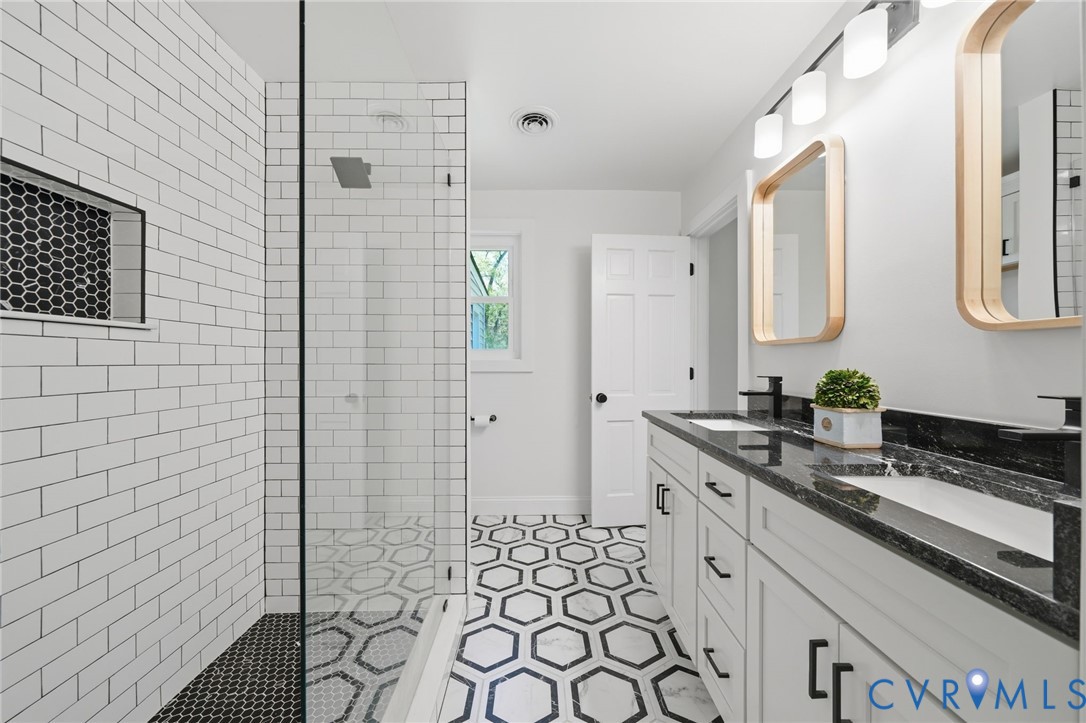 1100 Hollins Road Henrico, VA 23229 - Photo 20 of 38 a spacious bathroom with a sink a mirror and shower