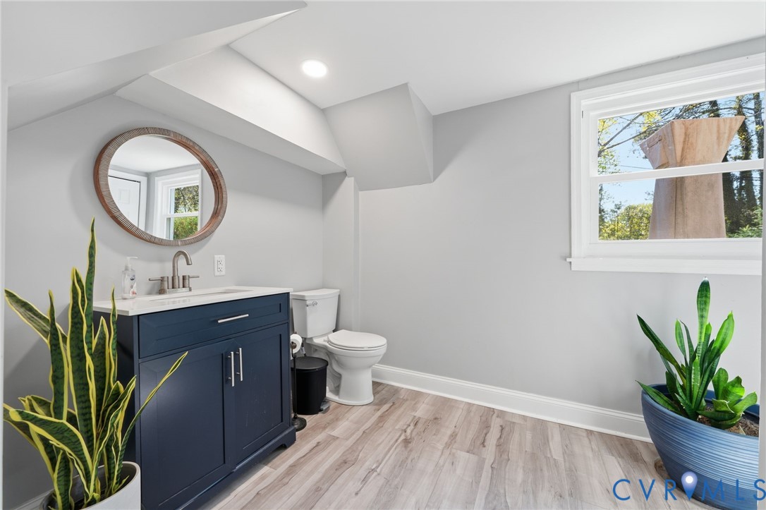 1100 Hollins Road Henrico, VA 23229 - Photo 26 of 38 a bathroom with a toilet a sink and a mirror