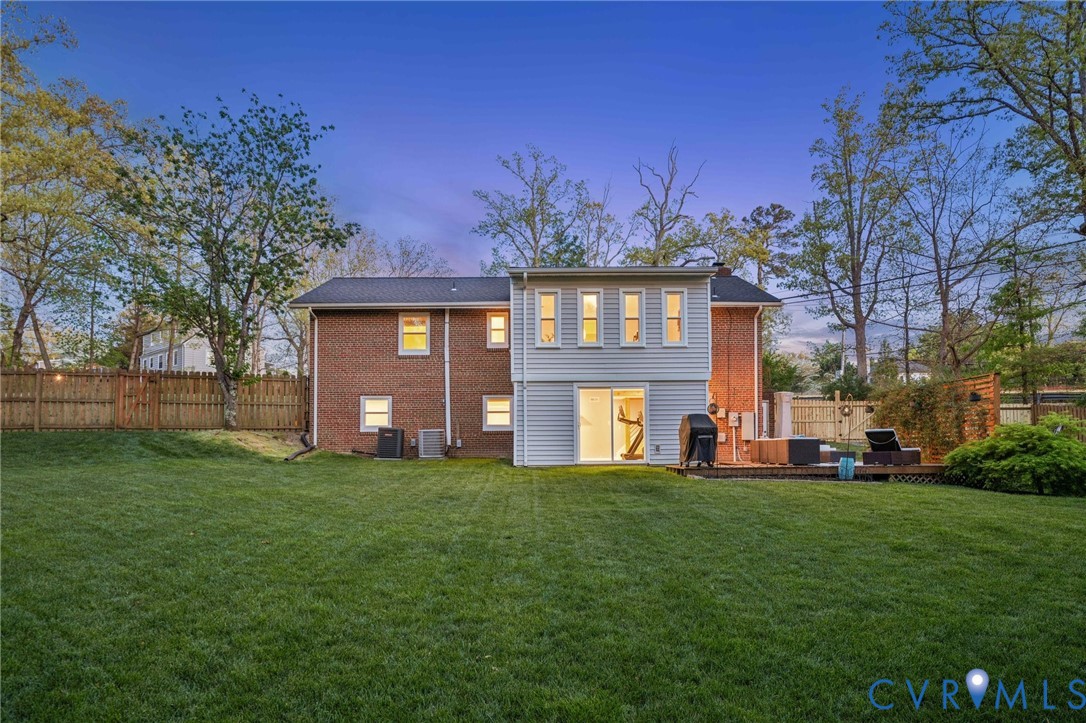 1100 Hollins Road Henrico, VA 23229 - Photo 6 of 38 a front view of a house with a garden and trees