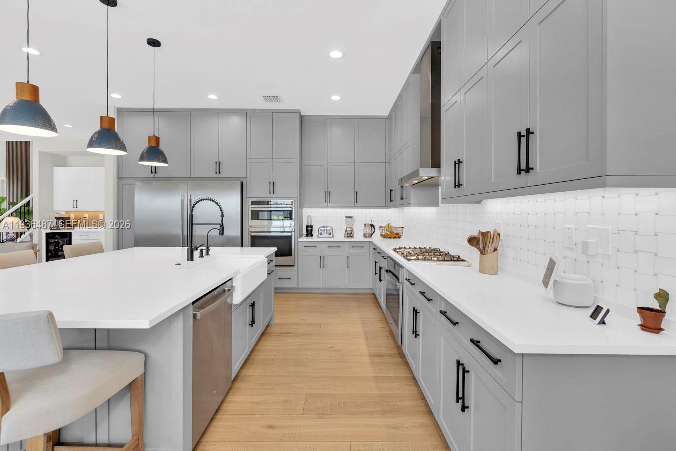 20310 Whistling Straits Way Boca Raton, FL 33434 - Photo 15 of 73 a kitchen with kitchen island a sink a stove and a refrigerator