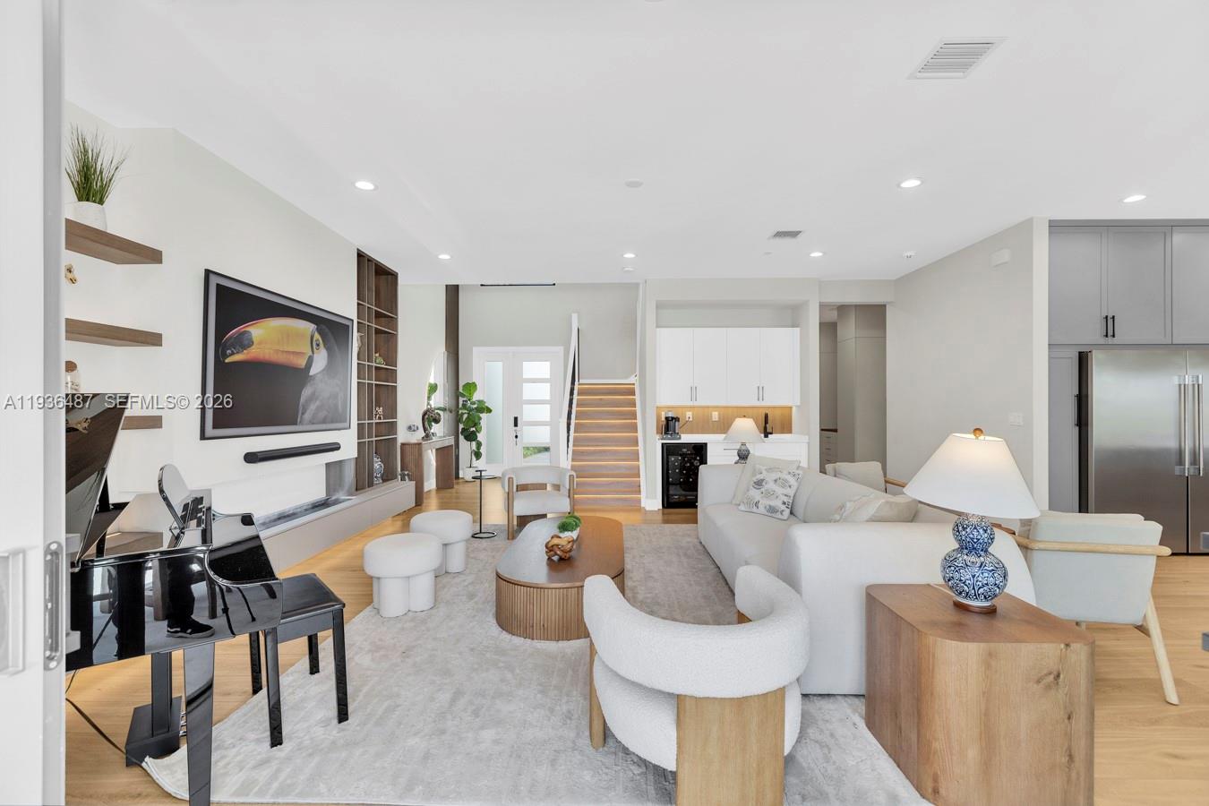 20310 Whistling Straits Way Boca Raton, FL 33434 - Photo 3 of 73 a living room with furniture a flat screen tv and kitchen view