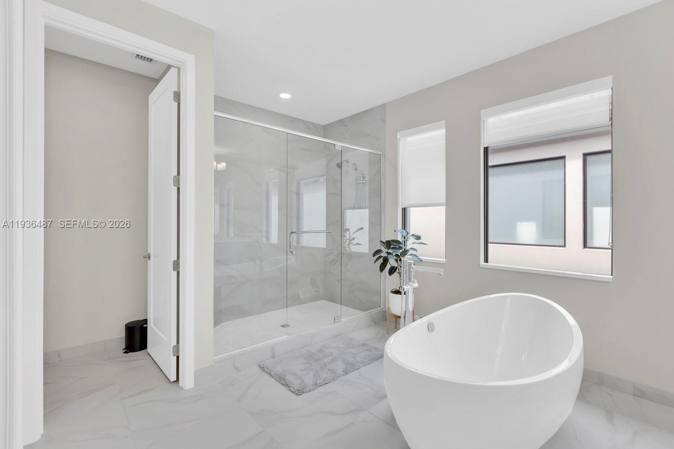 20310 Whistling Straits Way Boca Raton, FL 33434 - Photo 37 of 73 a spacious bathroom with a bathtub and shower