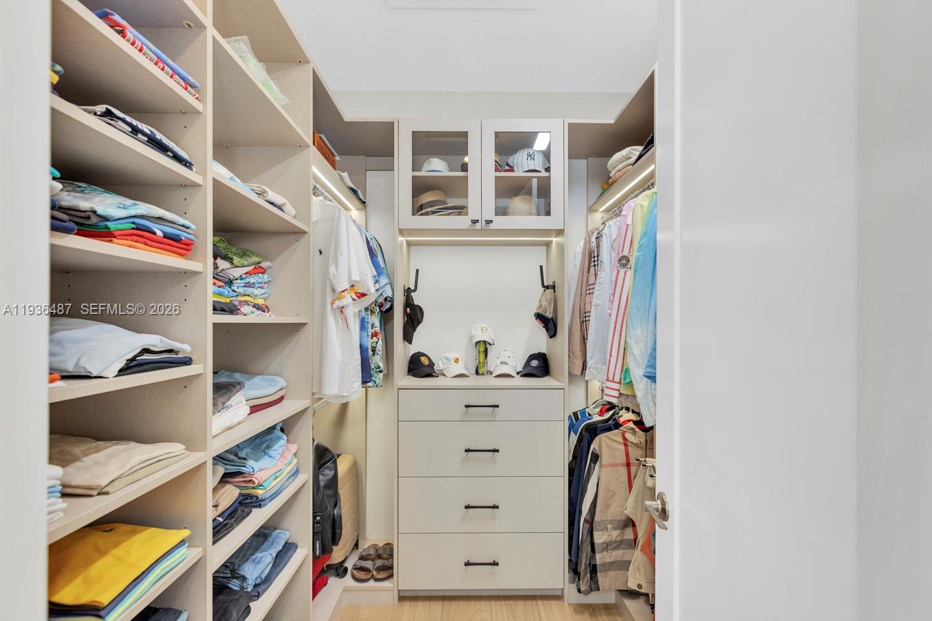 20310 Whistling Straits Way Boca Raton, FL 33434 - Photo 46 of 73 a view of walk in closet with clothes and shoes