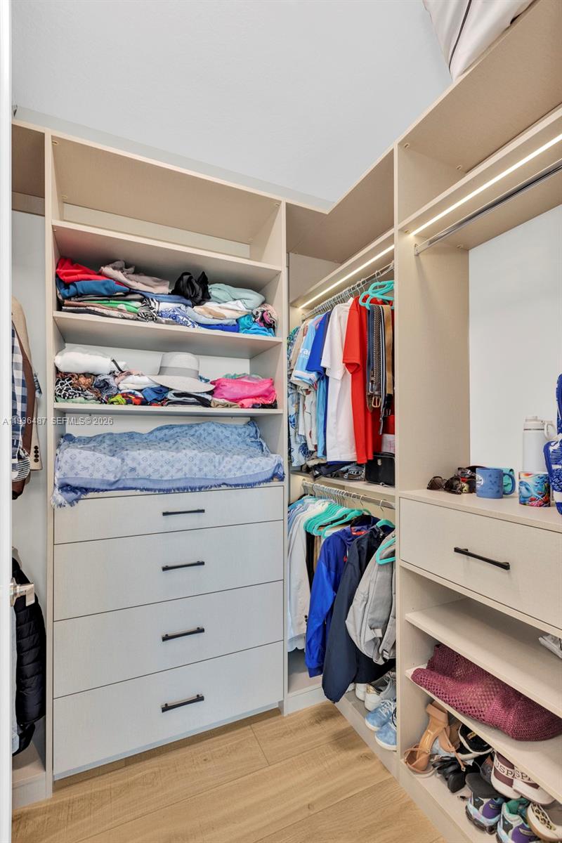 20310 Whistling Straits Way Boca Raton, FL 33434 - Photo 50 of 73 a view of walk in closet with clothes and shoes